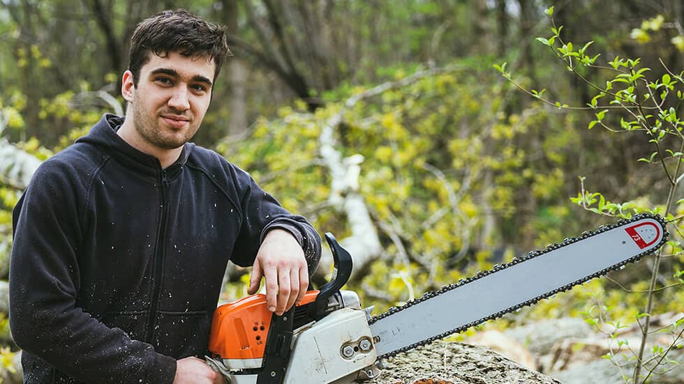 A Man with Chain Saw Machine who is professional arborist Tree Service Yuba City Ca